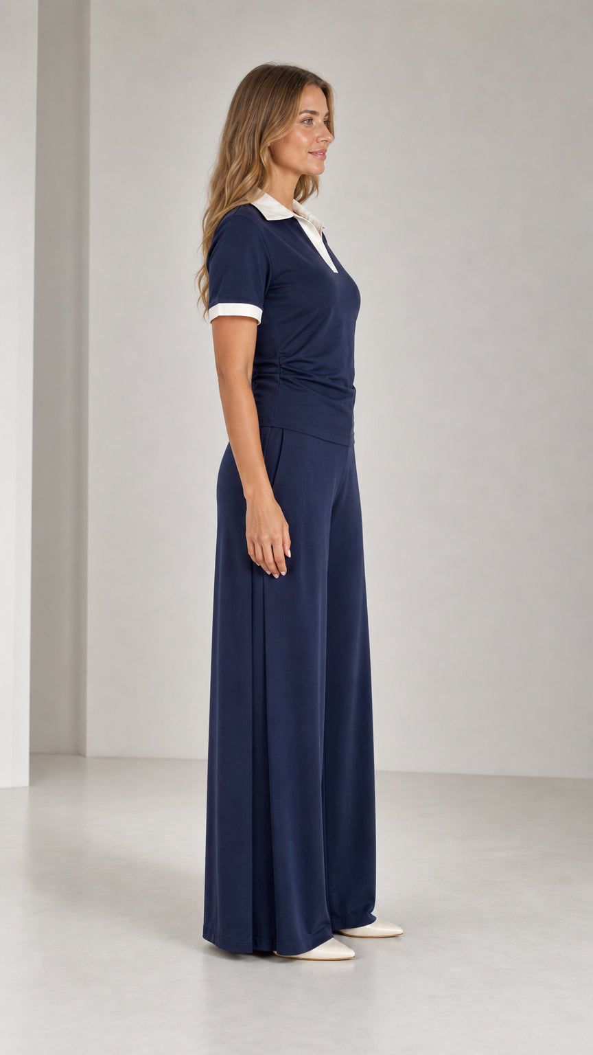 Side profile view of Navy Blue matching polo top and fluid wide-leg trouser set