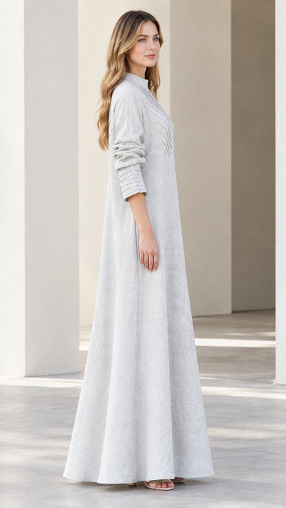 Side profile view of light grey pleated long sleeve A-line maxi dress