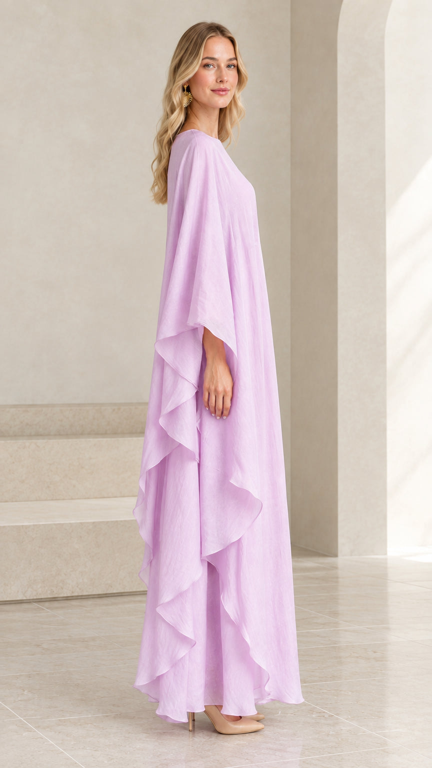 Side angle view of flowing lilac cape-sleeve maxi dress showing draped ruffles
