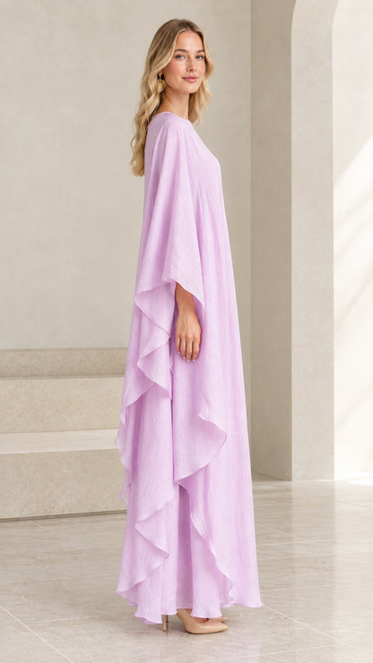Side angle view of flowing lilac cape-sleeve maxi dress showing draped ruffles