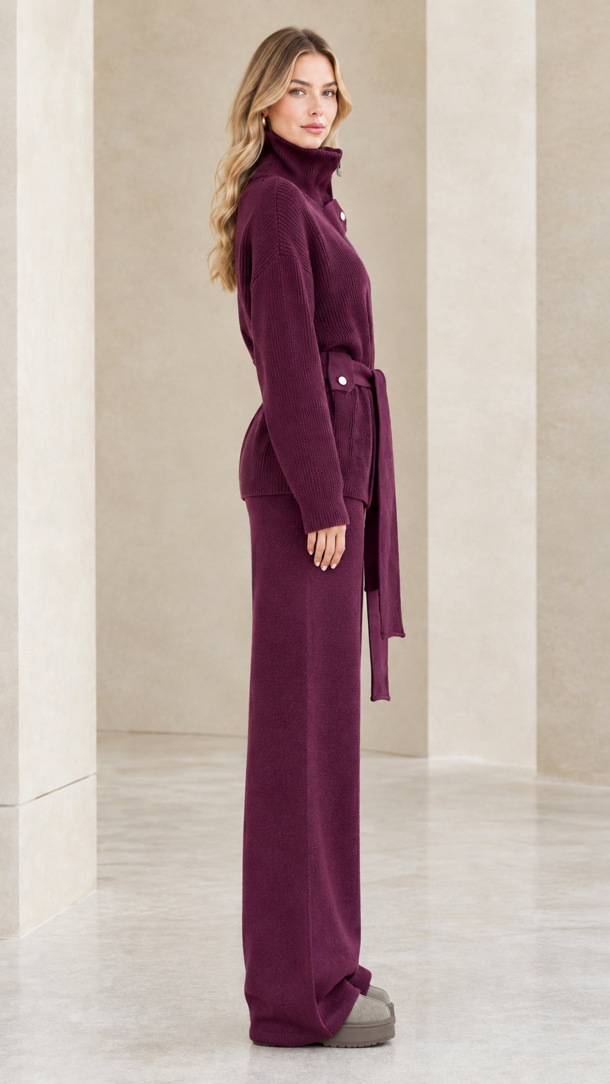 Side profile view of woman modeling the plum knit sweater and wide-leg trousers set