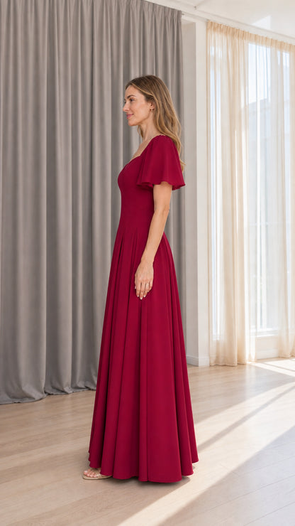 Side profile view of burgundy flutter sleeve maxi dress