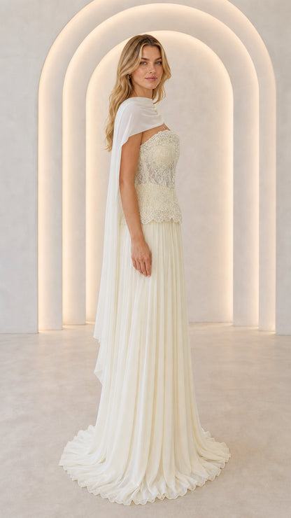 Ivory formal evening gown with lace bodice and side cape drape - three-quarter view