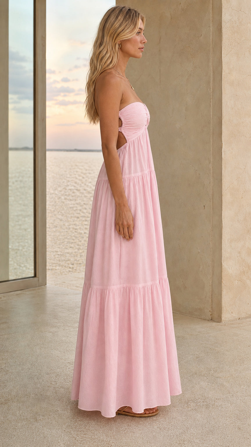 Side view of a pink open-back tiered maxi dress