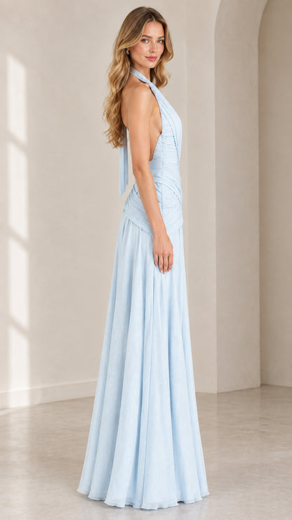 Side view of woman in sky blue halter maxi gown