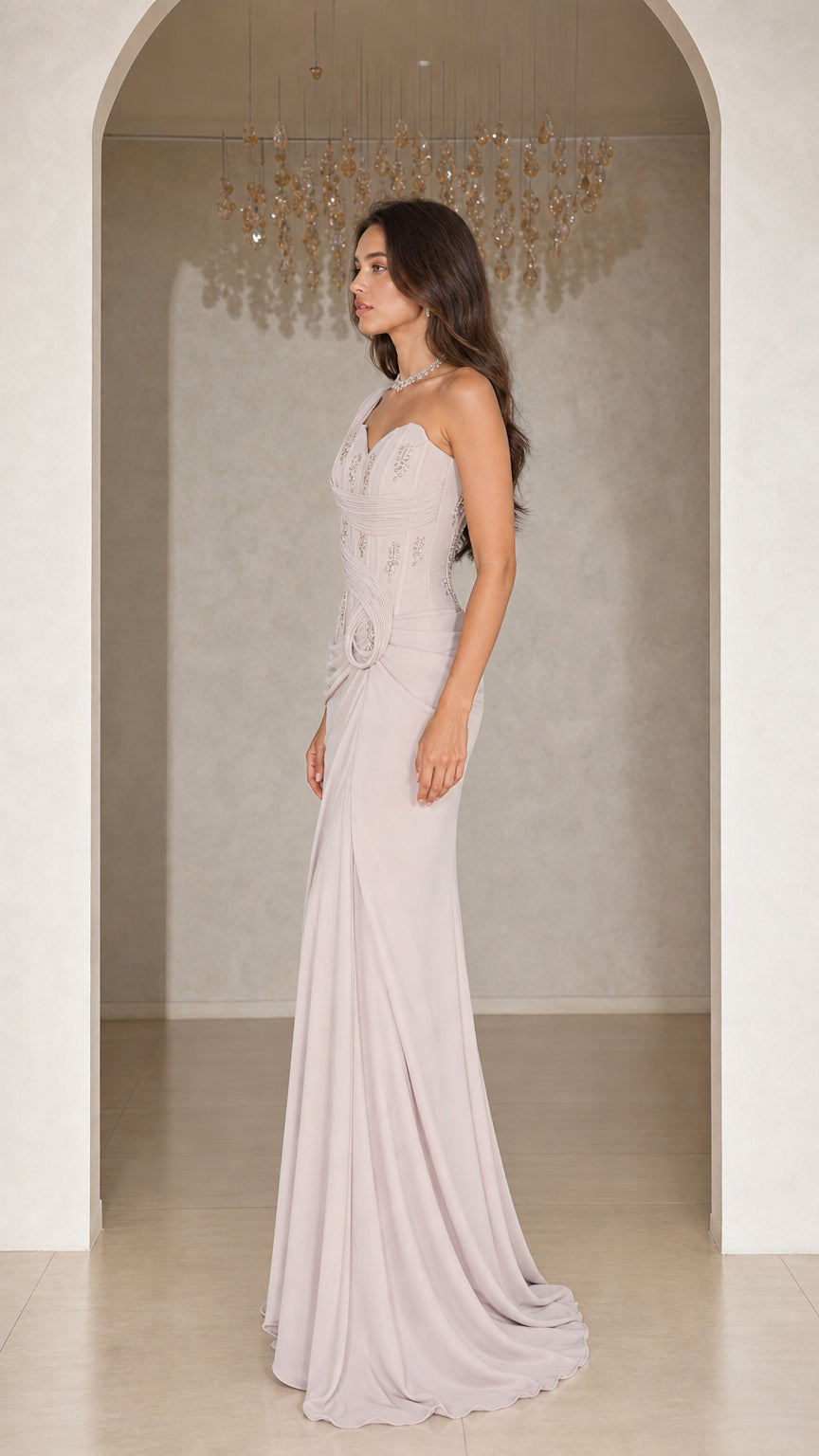 Side view of woman wearing silver grey one-shoulder formal dress