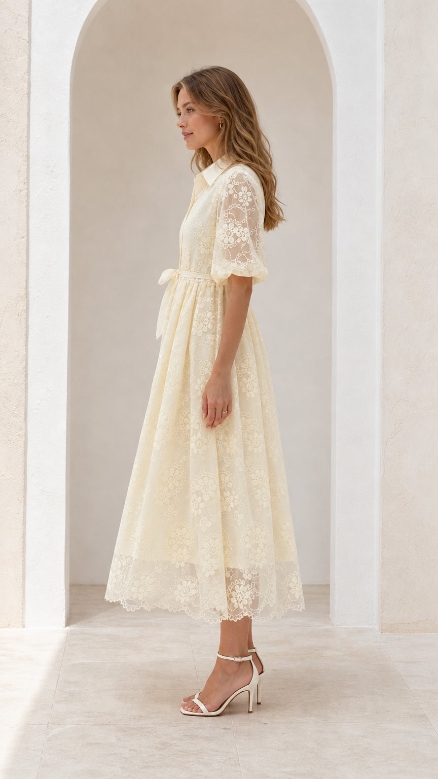 Side profile view of cream lace midi dress with elbow-length puff sleeves