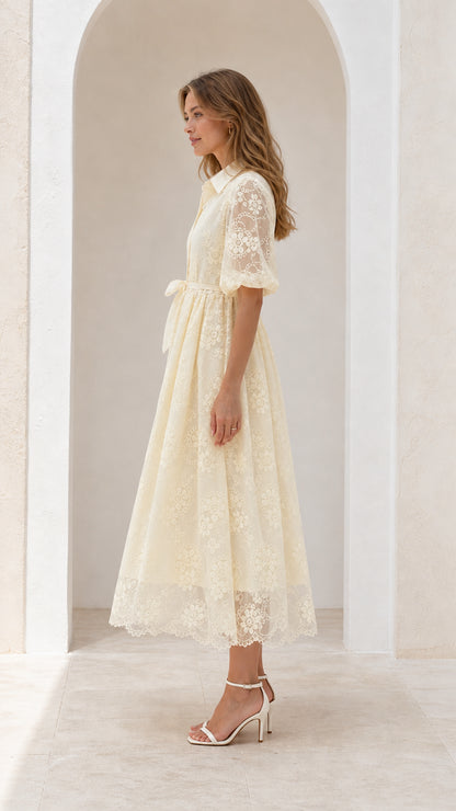 Side profile view of cream lace midi dress with elbow-length puff sleeves