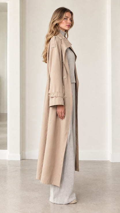 Side view of woman wearing beige longline duster coat