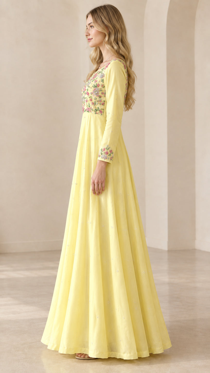 Side profile of women's flowing yellow embroidered evening gown