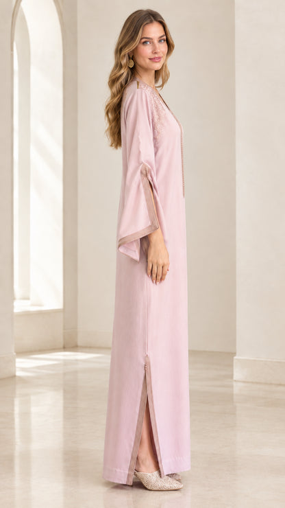 Side profile of woman wearing Dusty Pink kaftan dress highlighting sleeve slits and straight silhouette
