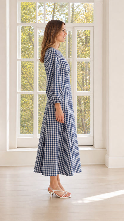 Side view of woman wearing blue gingham midi dress