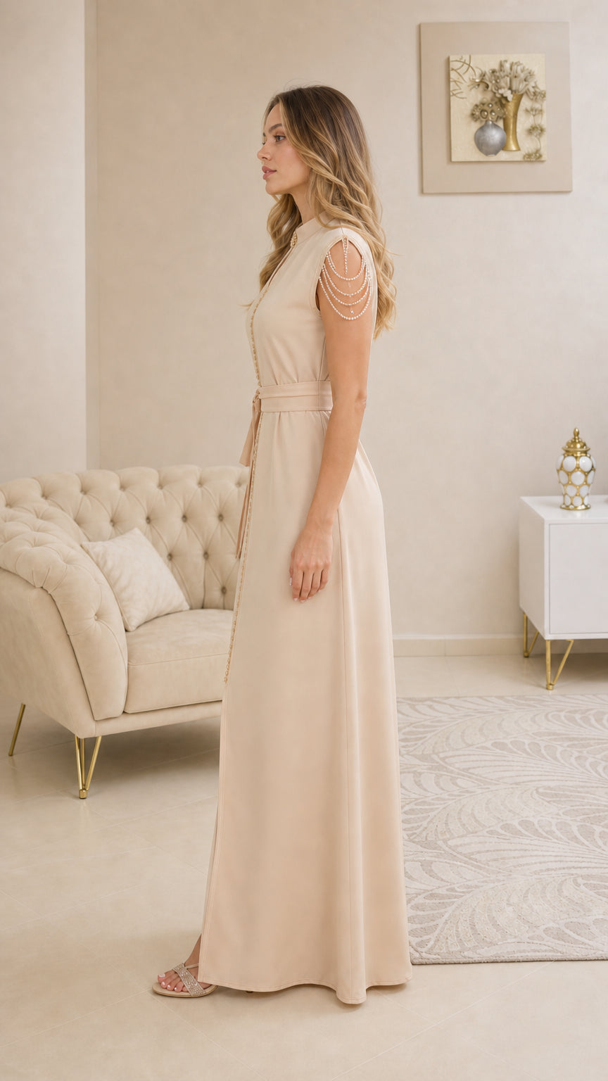 Side profile view of elegant beige floor-length evening dress with waist tie belt