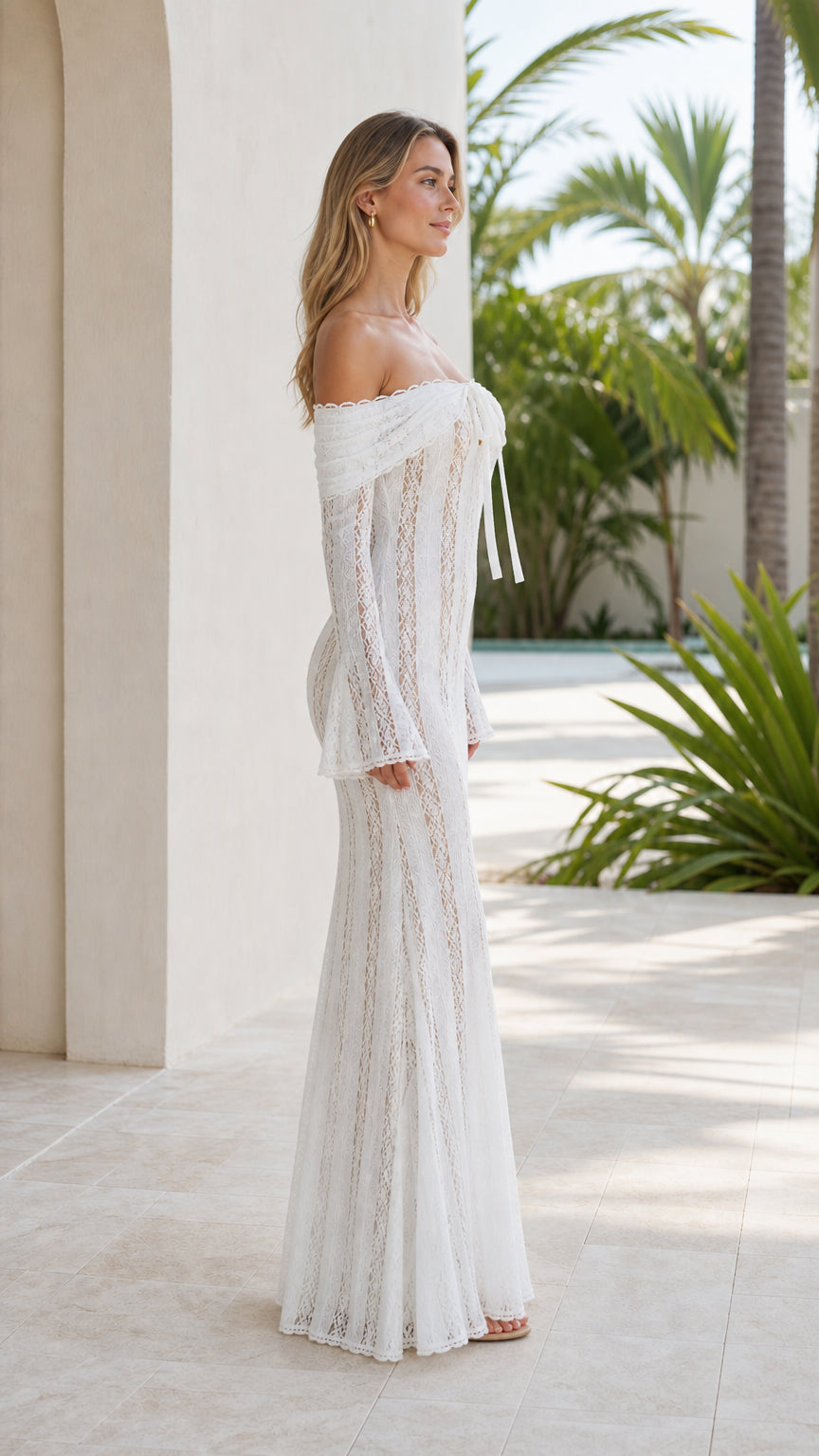 Side profile of model in white open-knit sheer maxi dress with flared sleeves