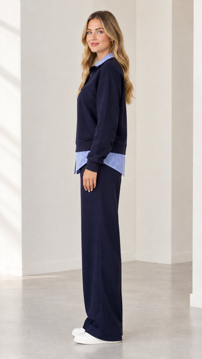Side profile view of navy blue layered sweatshirt and wide leg trousers set
