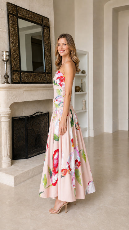 Side profile of model in pink floral strapless maxi dress