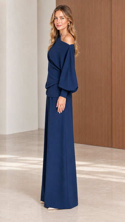 Side view of model wearing Navy Blue draped one-shoulder pant set