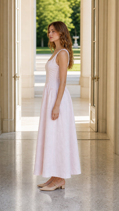 Side profile of model in pink lace up midi dress