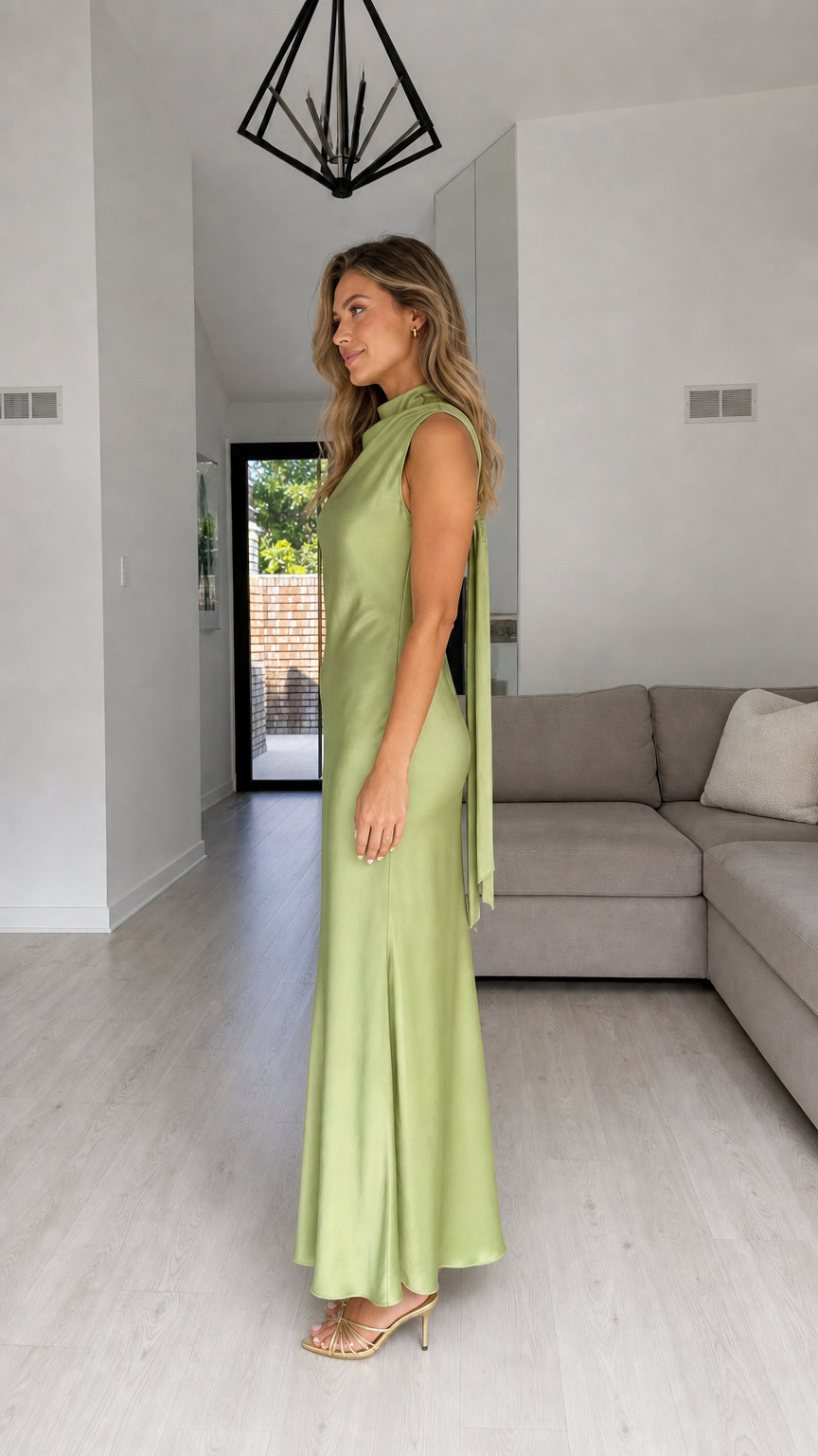 Side profile of model in sage satin maxi dress