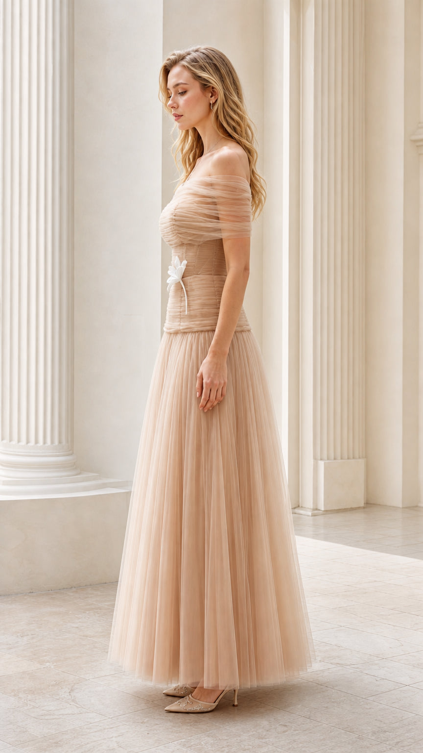 Side view of model wearing champagne drop-waist tulle evening dress