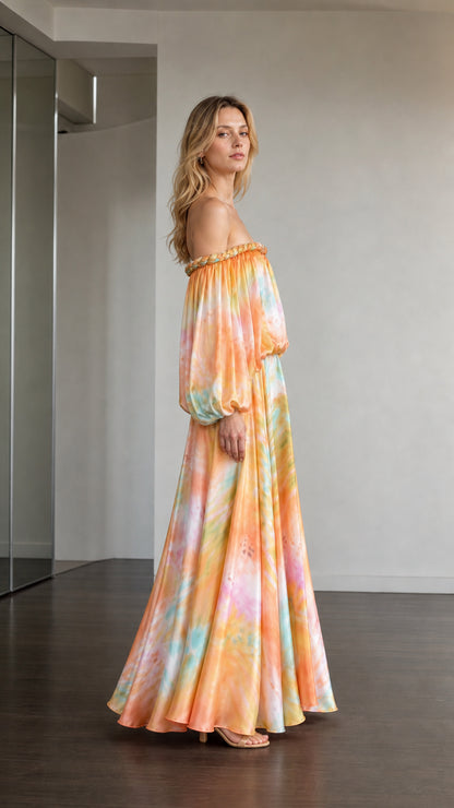 Side profile of model in orange multi tie-dye maxi dress
