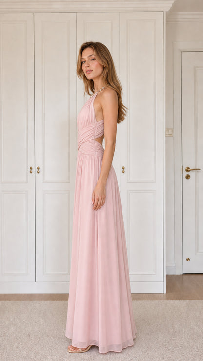 Side angle of woman in blush pink pleated maxi bridesmaid dress