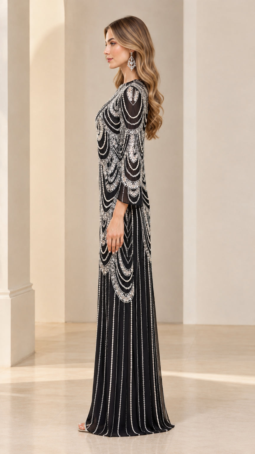Side profile view of black beaded maxi gown showcasing flared sleeves and column drape