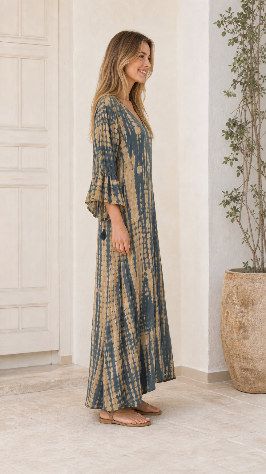Side profile of model wearing Blue tie-dye maxi dress