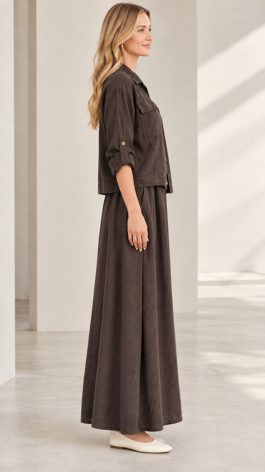 Side profile view of dark brown two-piece shacket and maxi skirt outfit