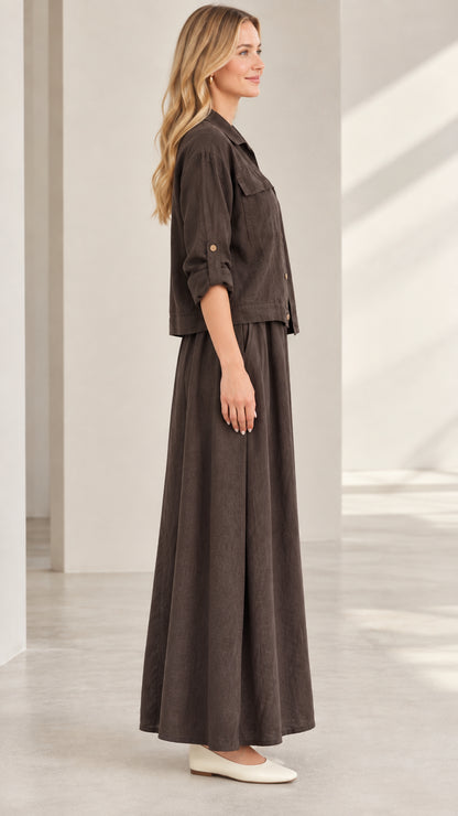 Side profile view of dark brown two-piece shacket and maxi skirt outfit