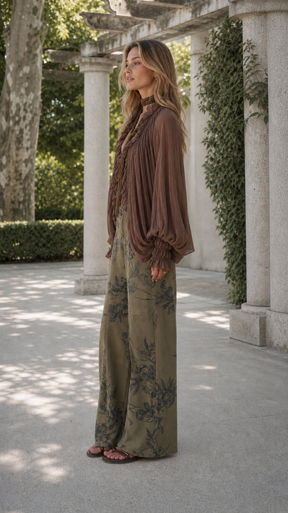 Model side profile in boho balloon sleeve blouse and olive floral wide-leg pants
