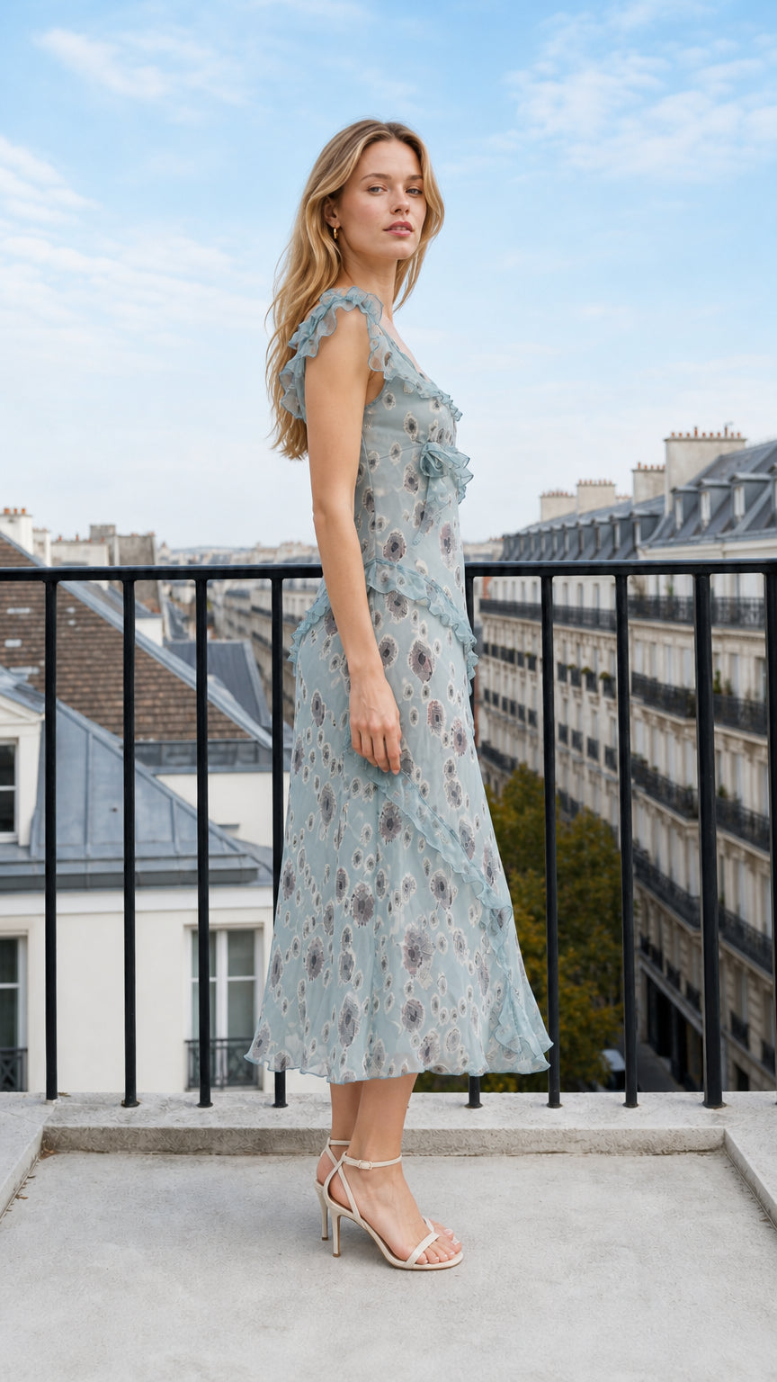 Side angle view of model wearing dusty blue floral ruffle midi dress