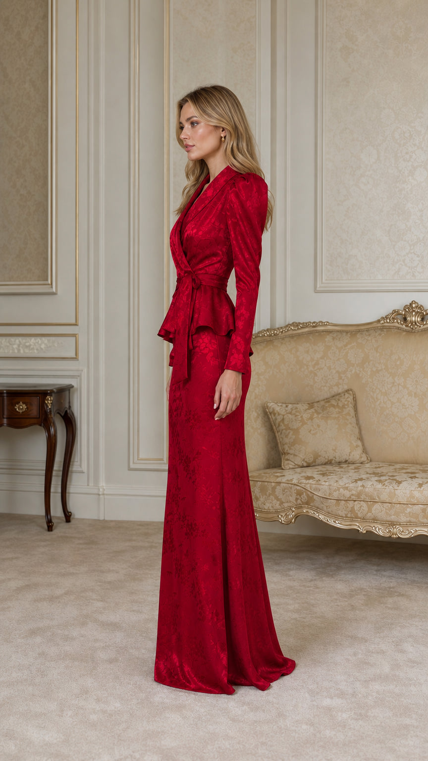 Side profile of woman in red puff shoulder jacquard formal gown