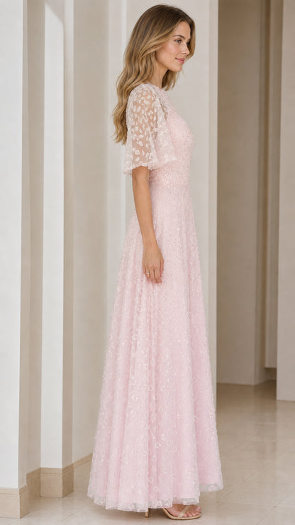 Side profile of woman in blush pink sequin A-line evening dress
