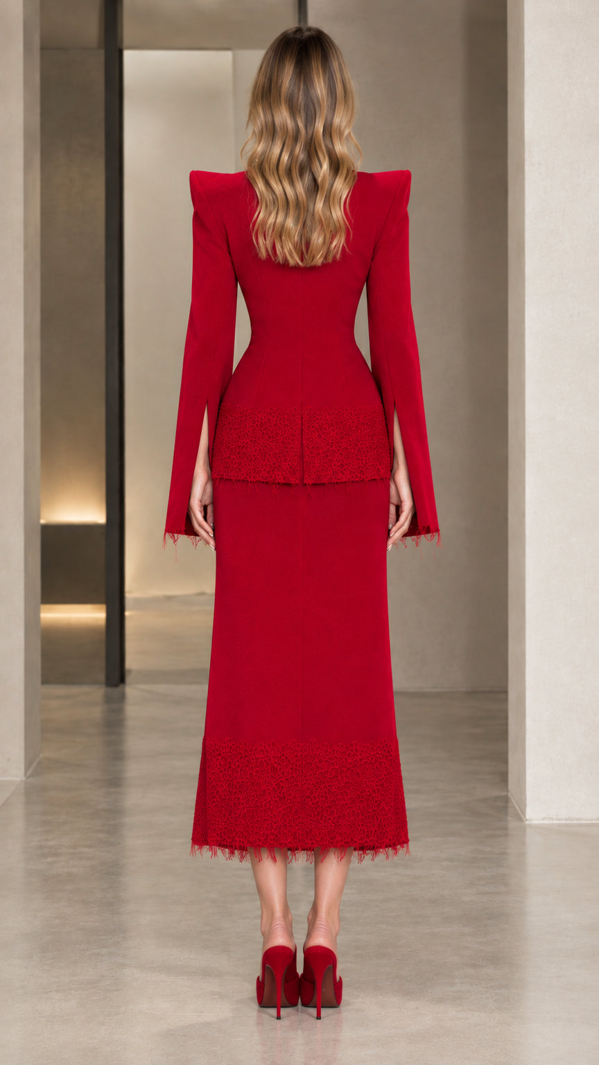 Back view of the red two-piece suit featuring sculpted waist and shoulders