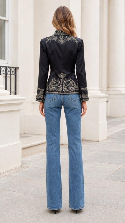 Back view of black embroidered jacket showcasing intricate floral details at upper back and hem