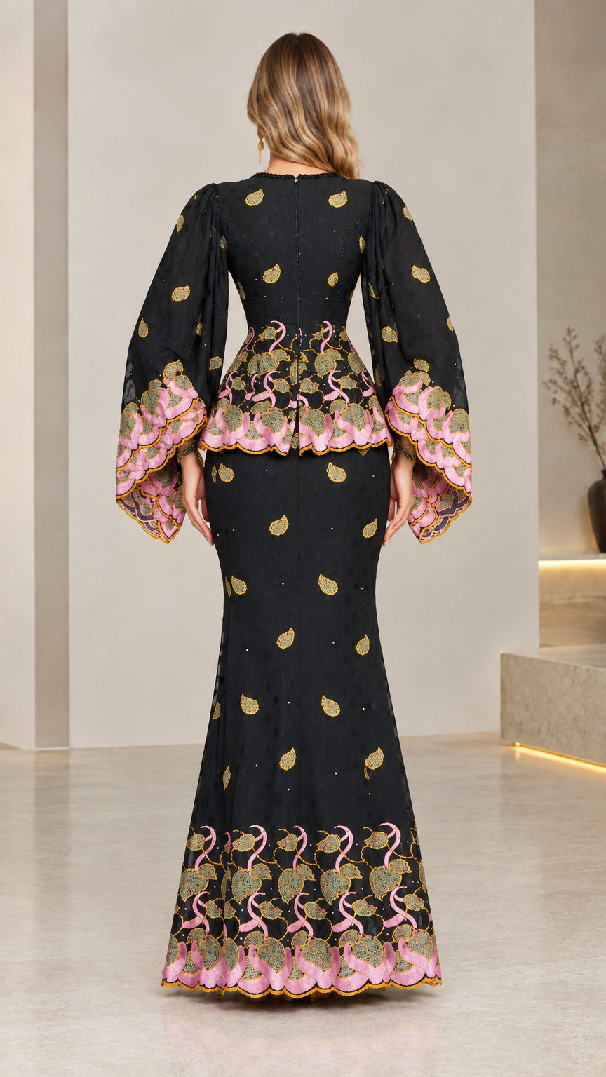 Back view of model in elegant black peplum maxi dress with embroidered borders