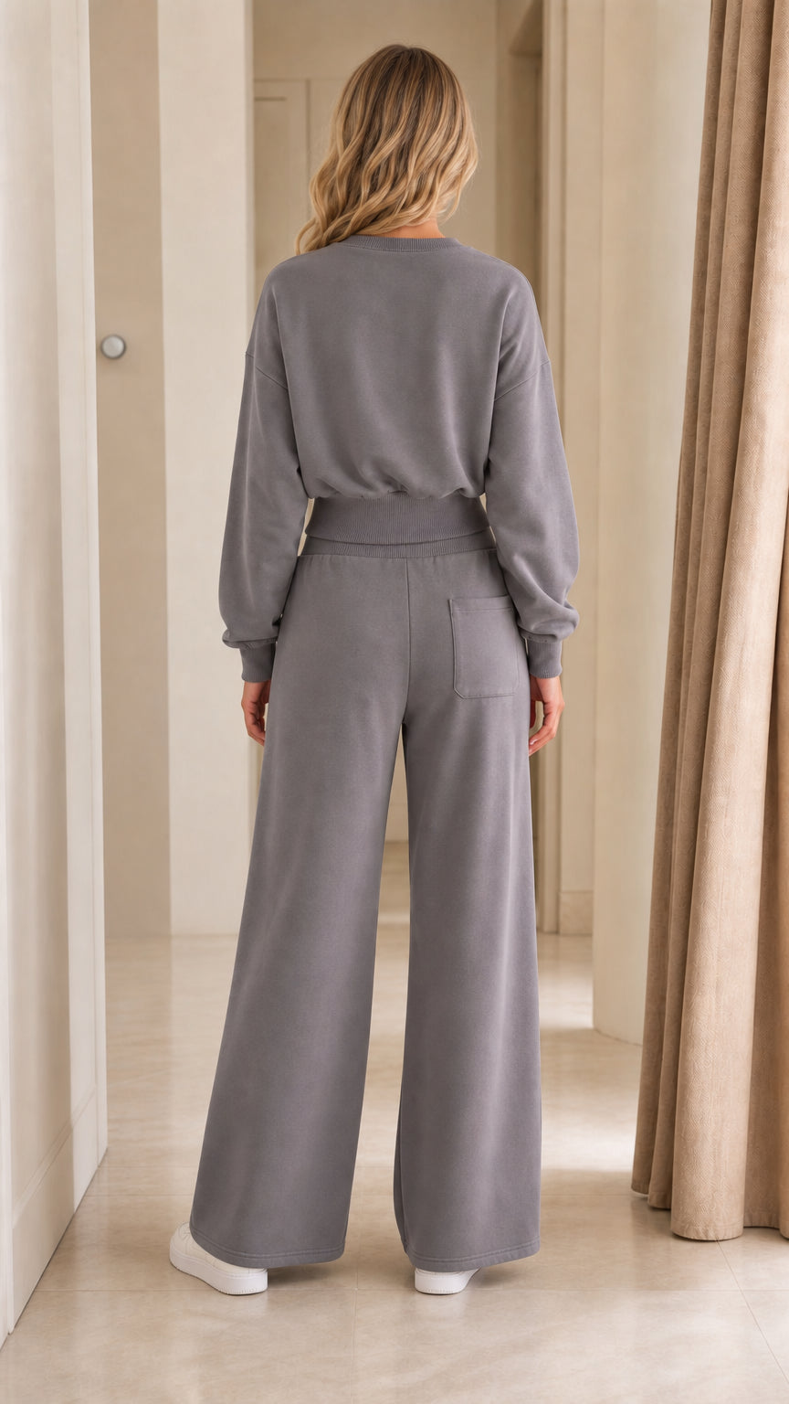 Back view of woman wearing slate grey crewneck top and wide-leg sweatpants