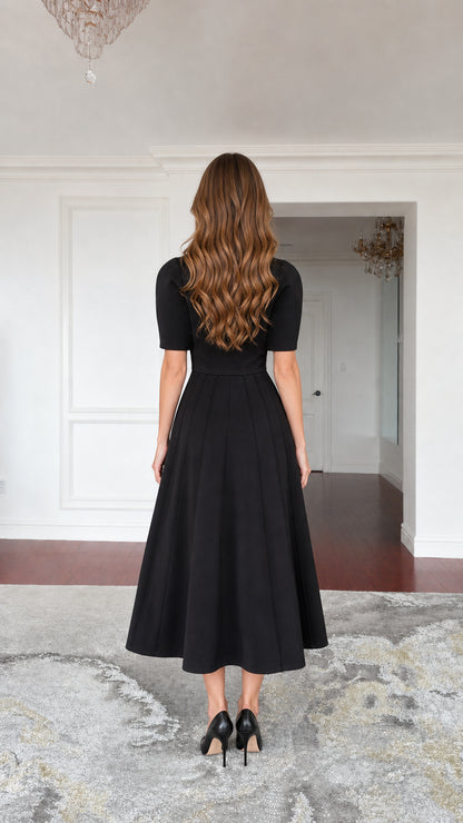 Back view of black cape midi dress