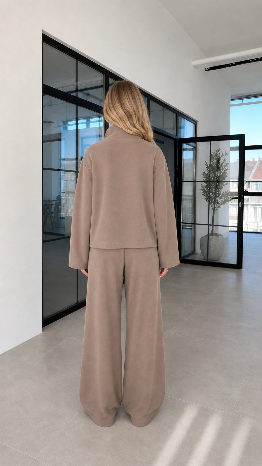 Woman wearing taupe lounge set back view