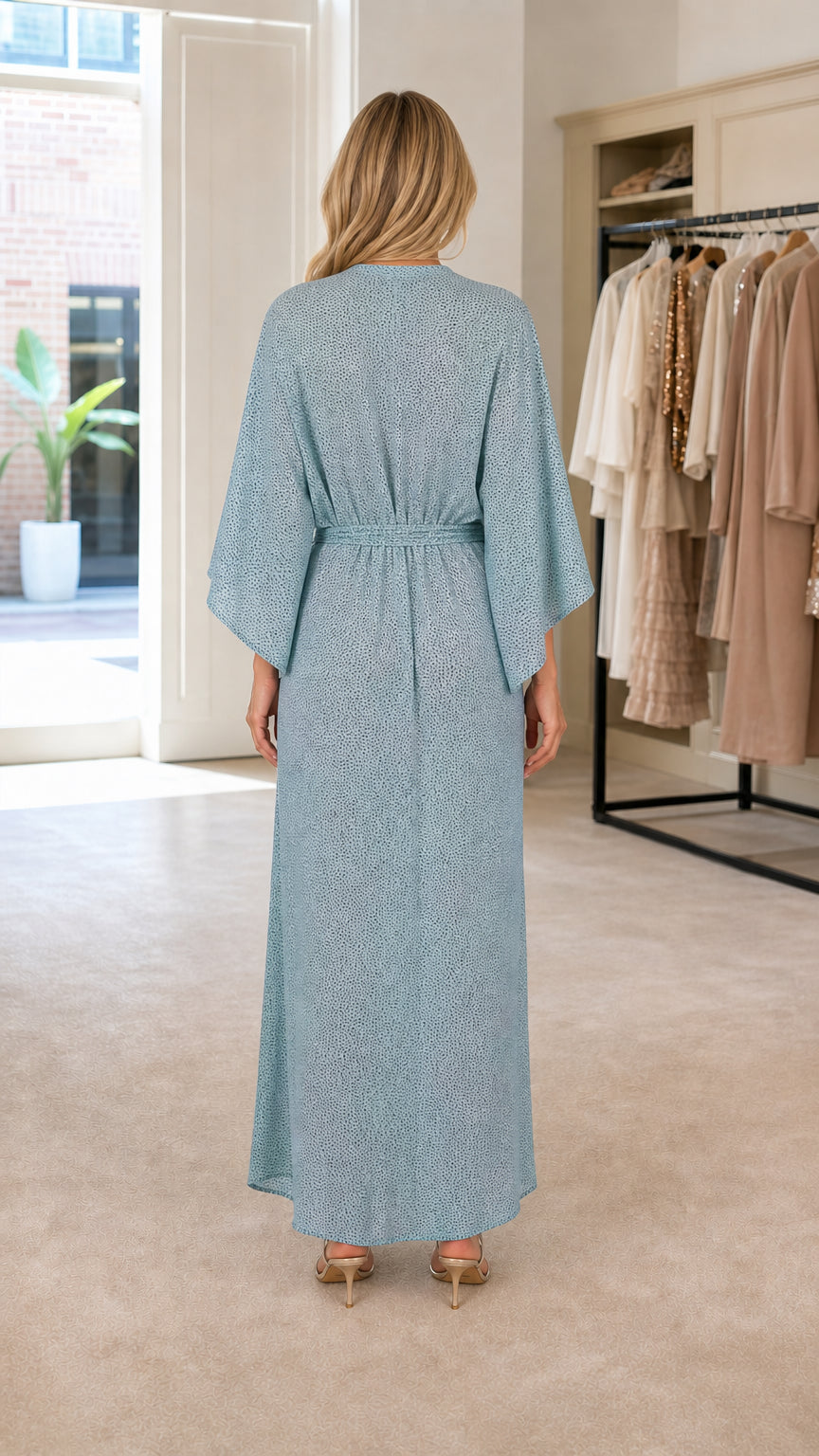 Back view of woman wearing light blue flowing maxi dress