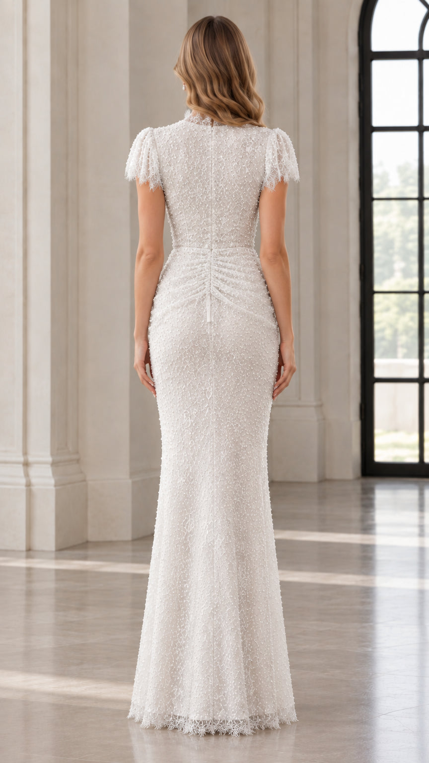 Back view of model in white sequin evening gown with ruched detailing and zip closure