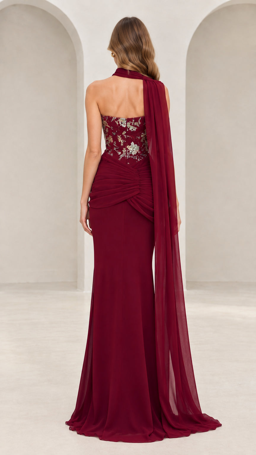Back view of burgundy floor-length evening dress showcasing cascading chiffon cape