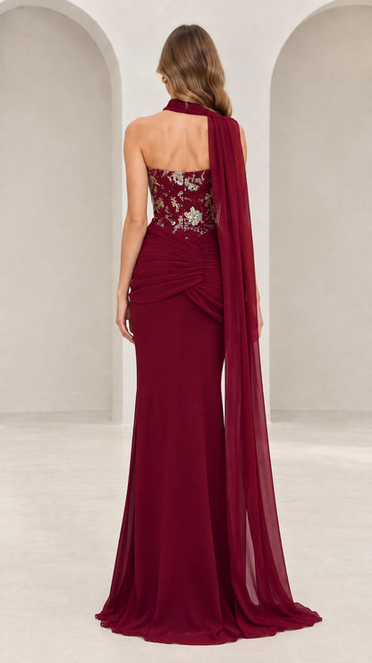 Back view of burgundy floor-length evening dress showcasing cascading chiffon cape