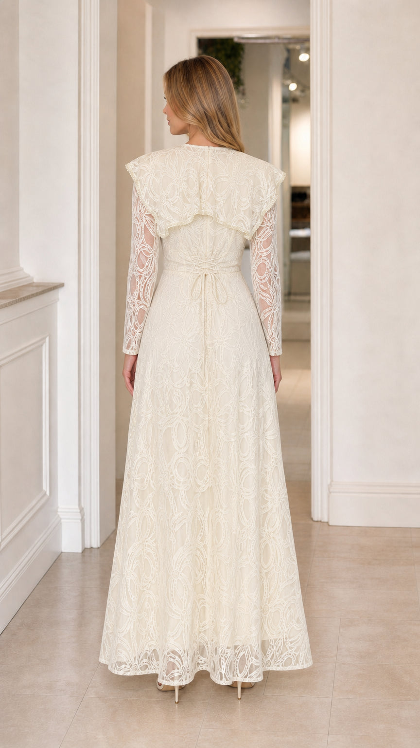 Back view of the Ivory Lace Capelet Maxi Dress showing the capelet drape and waist tie