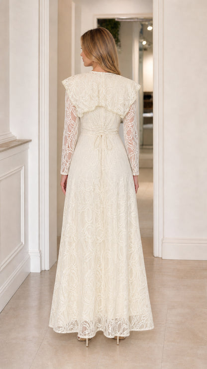 Back view of the Ivory Lace Capelet Maxi Dress showing the capelet drape and waist tie