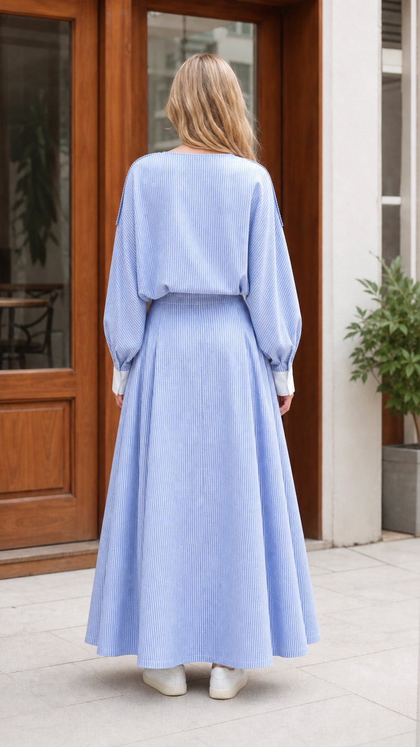 Back view of model wearing light blue boat neck blouson maxi dress