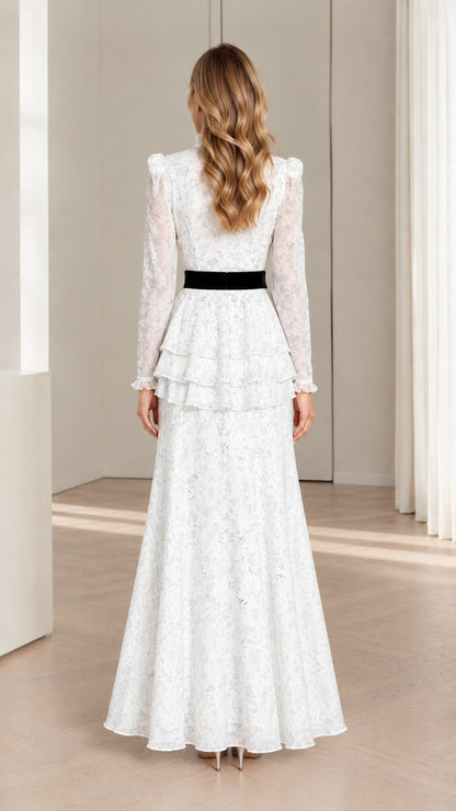 Back view of white floral maxi dress showing rear velvet tie bow and zipper closure
