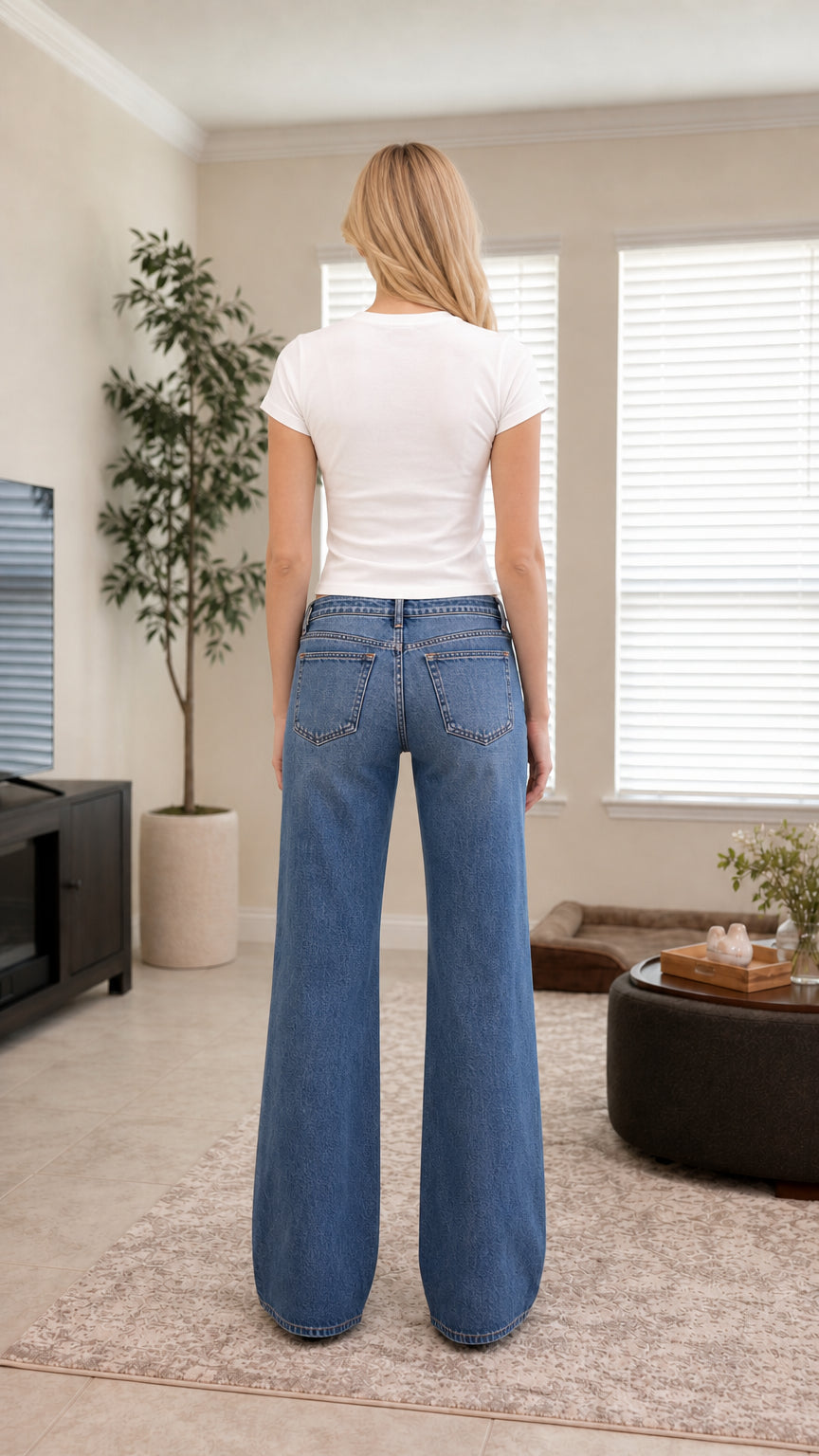 Back view of high-waisted medium blue wide-leg jeans with back pockets