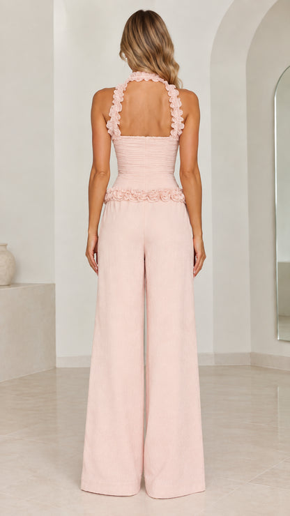 Back view of model in Blush Pink ruffle halter wide-leg jumpsuit